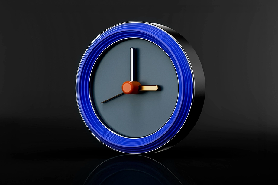 3D-rendered clock with blue outer rim, orange center, and gold and white clock hands on a dark background